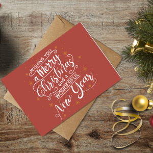 christmas themed holiday greeting card with a kraft envelope top view mockup template 655b42cda2064af79c46d381@2x